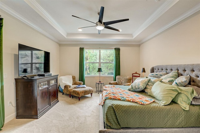 bedroom with a raised ceiling, ceiling fan, crown molding, and light carpet