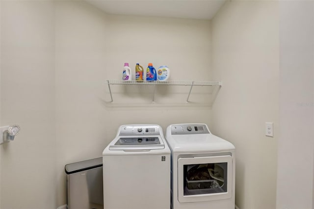 clothes washing area featuring washer and clothes dryer