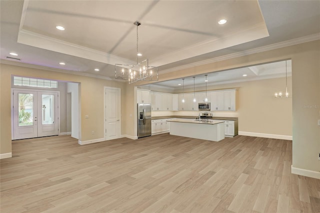 kitchen with french doors, white cabinets, stainless steel appliances, and light wood-type flooring