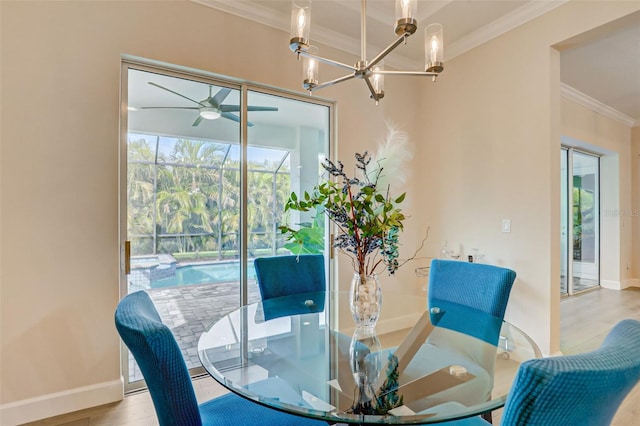 dining space with ceiling fan with notable chandelier, light hardwood / wood-style flooring, and ornamental molding