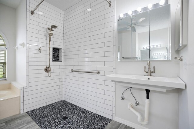 bathroom featuring a garden tub, ceiling fan, and a tile shower