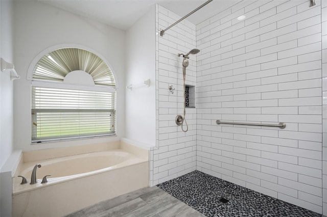 full bath featuring a bath, tiled shower, and wood finished floors