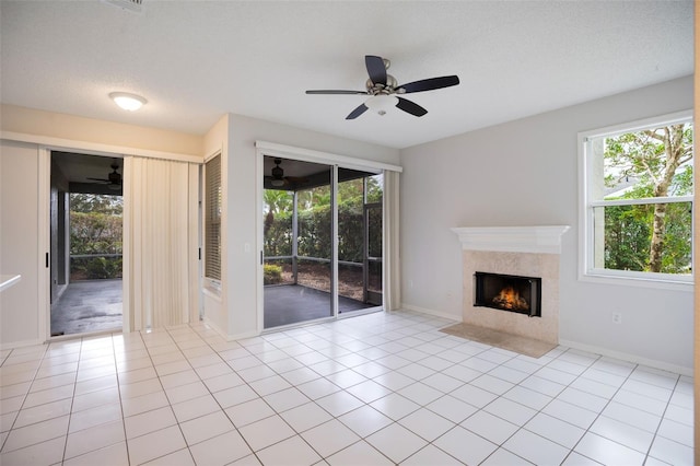 unfurnished living room featuring light tile patterned floors, a fireplace, and a textured ceiling