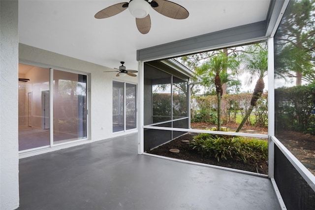 unfurnished sunroom with ceiling fan