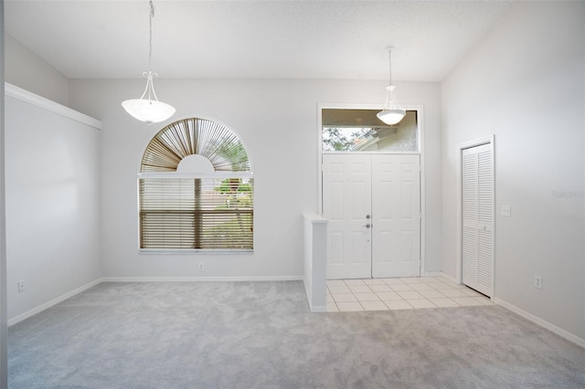 foyer with carpet floors and baseboards