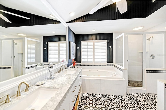 bathroom featuring ceiling fan, tile patterned flooring, vaulted ceiling, vanity, and independent shower and bath