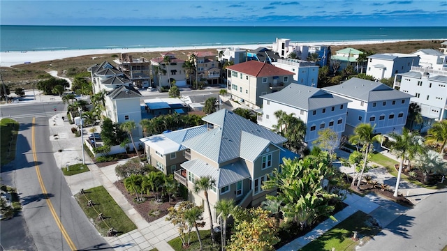 drone / aerial view featuring a water view and a view of the beach