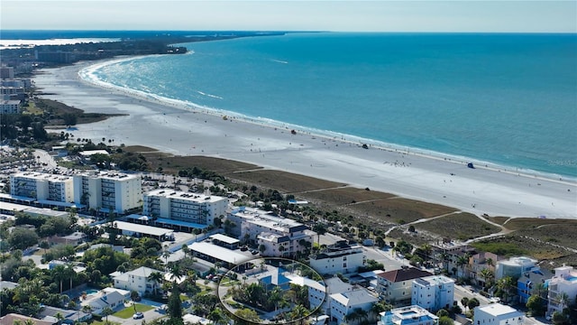 birds eye view of property with a beach view and a water view