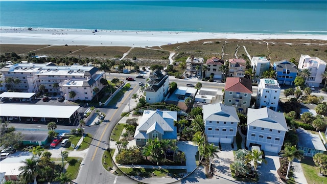 bird's eye view with a water view and a beach view