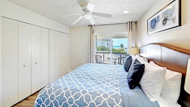 bedroom featuring access to exterior, ceiling fan, hardwood / wood-style floors, and a textured ceiling