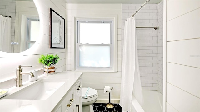 full bathroom with tile patterned flooring, vanity, shower / bath combo, and toilet