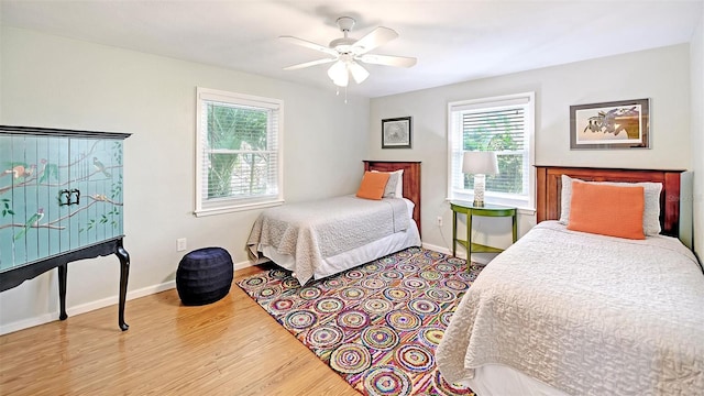 bedroom with ceiling fan and light wood-type flooring