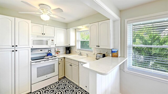 kitchen featuring white cabinets, white appliances, and sink