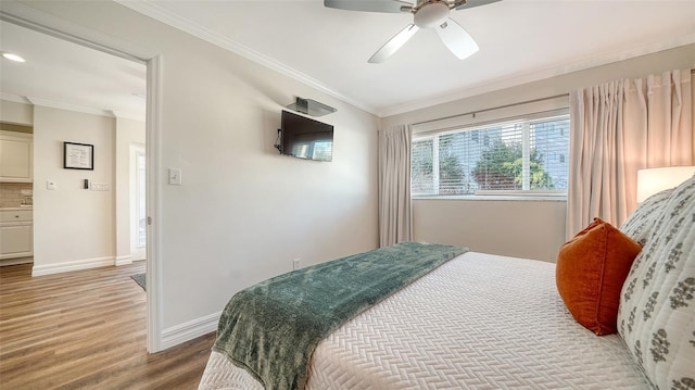 bedroom with ceiling fan, wood-type flooring, and crown molding