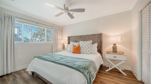 bedroom with crown molding, ceiling fan, and dark wood-type flooring