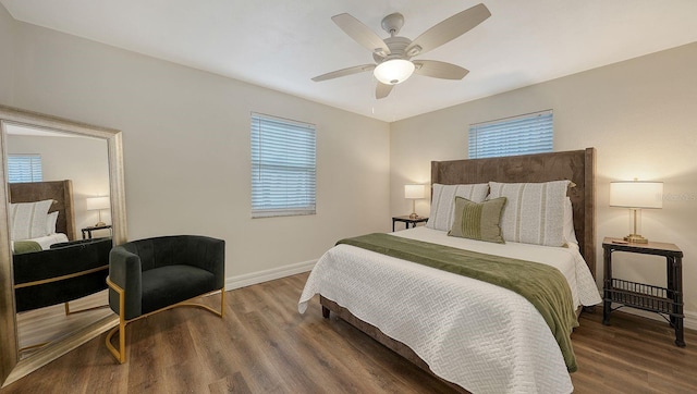 bedroom with dark hardwood / wood-style floors and ceiling fan