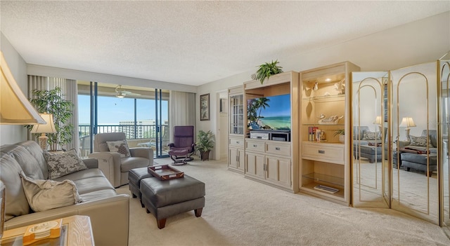 carpeted living room featuring a textured ceiling and ceiling fan