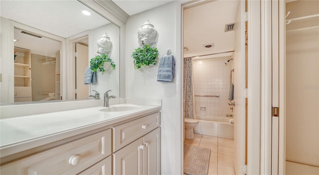 full bathroom featuring tile patterned floors, vanity, shower / tub combo, and toilet