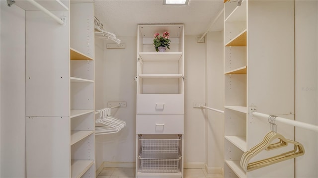 spacious closet featuring light tile patterned floors