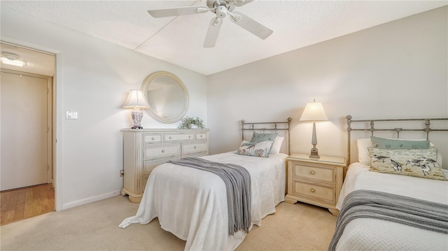 carpeted bedroom with a textured ceiling and ceiling fan