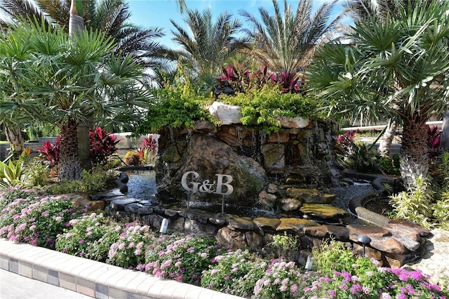 community / neighborhood sign with a garden pond