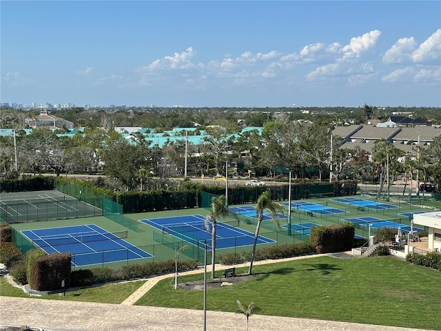 view of sport court with fence and a yard