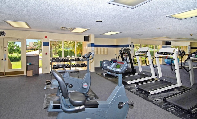exercise room with a textured ceiling and visible vents