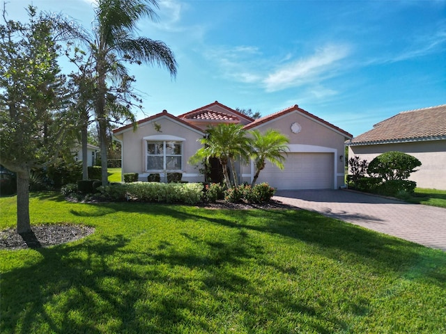 mediterranean / spanish-style house with a front yard and a garage