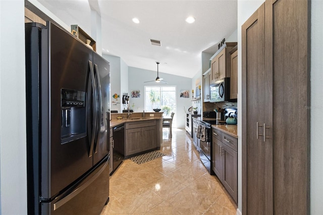 kitchen featuring ceiling fan, hanging light fixtures, stainless steel appliances, tasteful backsplash, and vaulted ceiling