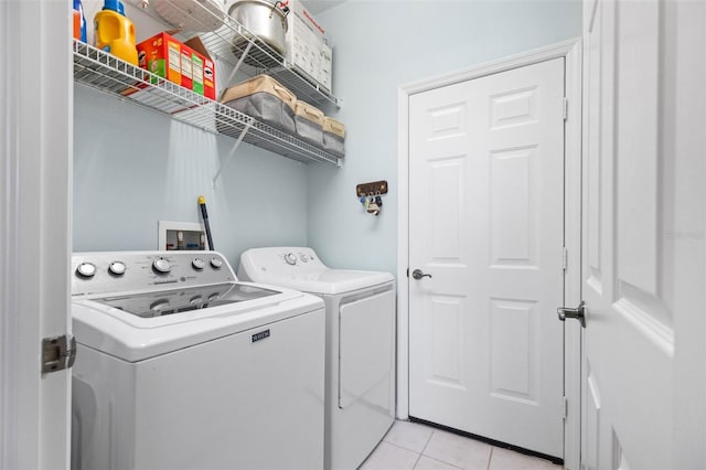 laundry area featuring light tile patterned flooring and washer and dryer