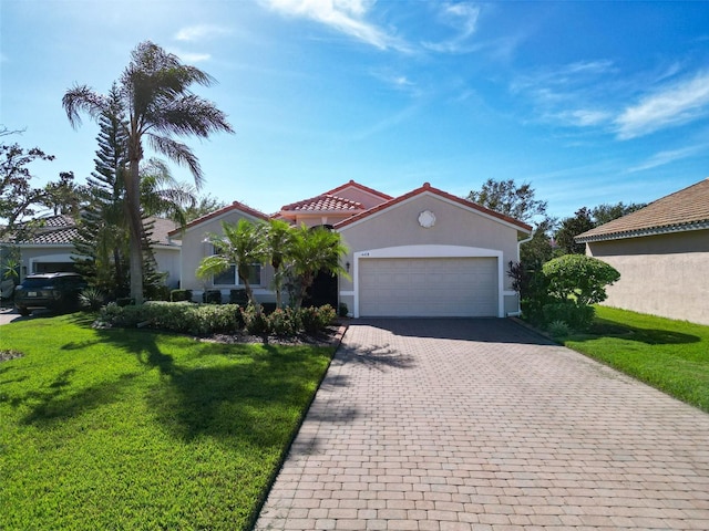 mediterranean / spanish-style home with a garage and a front yard