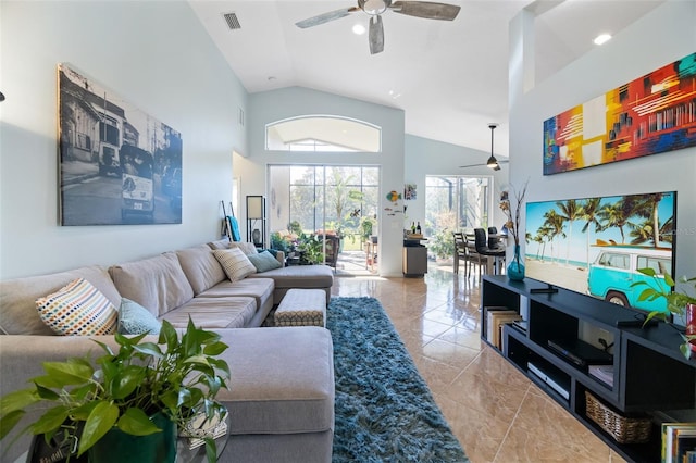 living room with ceiling fan and high vaulted ceiling