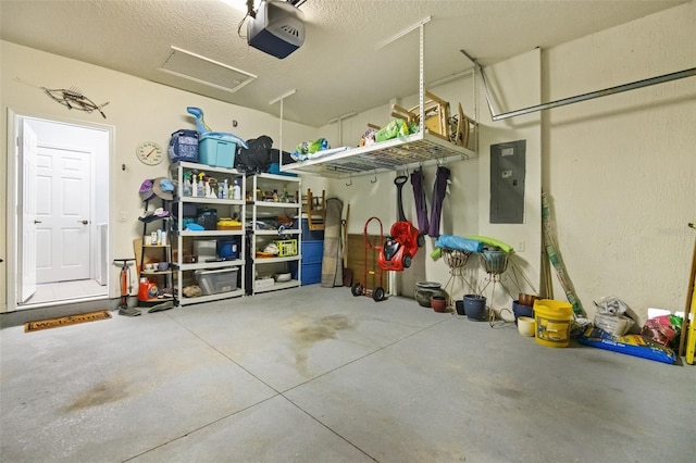 garage with electric panel and a garage door opener