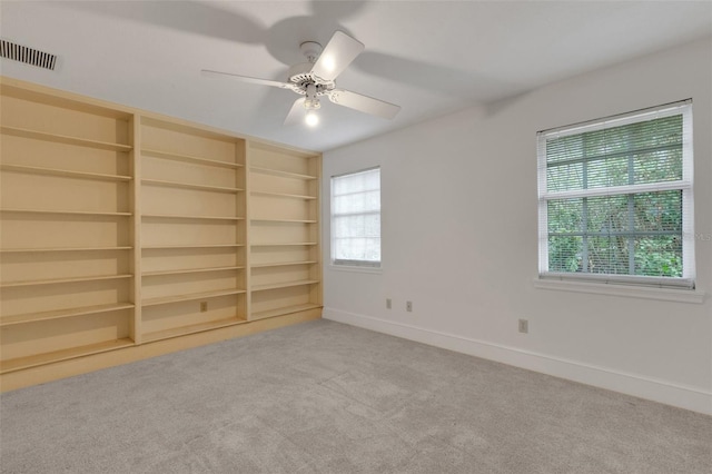 interior space with carpet flooring and ceiling fan