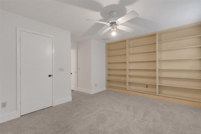 interior space with light carpet and ceiling fan