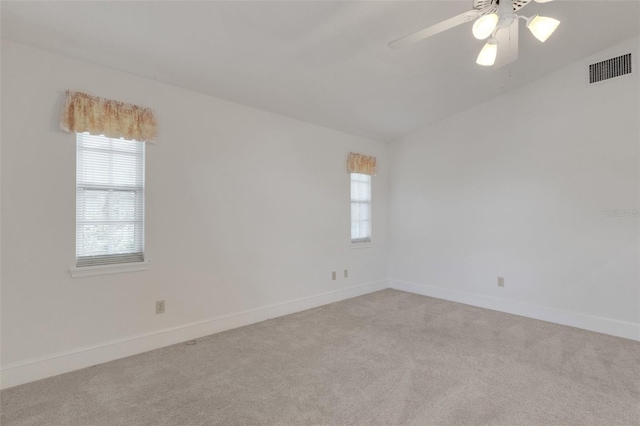 carpeted empty room featuring ceiling fan and lofted ceiling