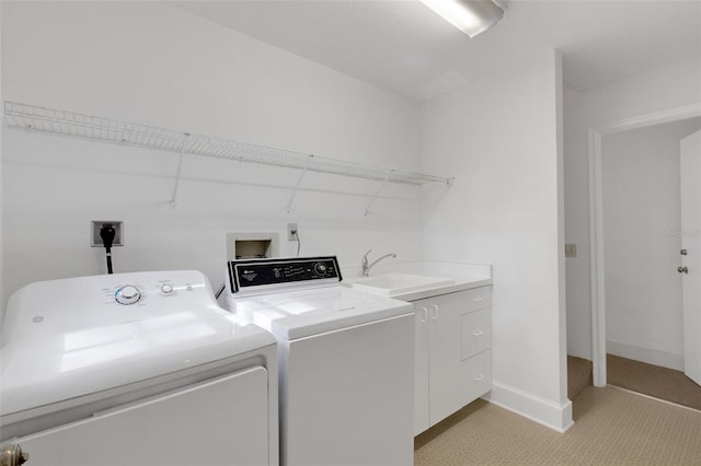 washroom featuring cabinets, separate washer and dryer, and sink