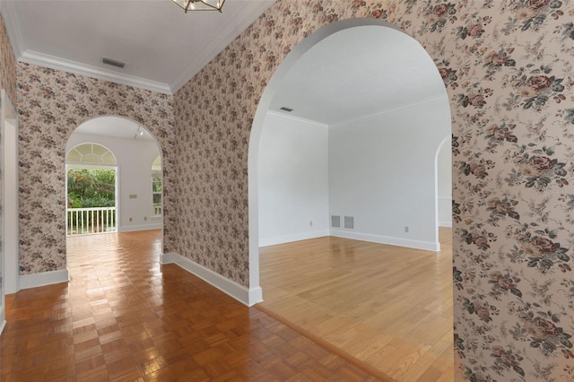 unfurnished room featuring hardwood / wood-style floors and ornamental molding