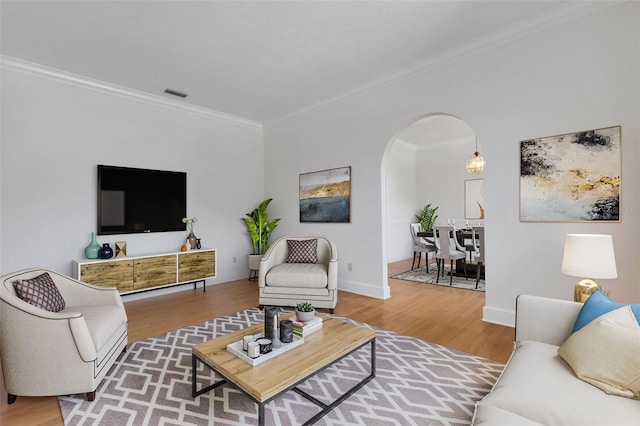 living room with crown molding and hardwood / wood-style floors