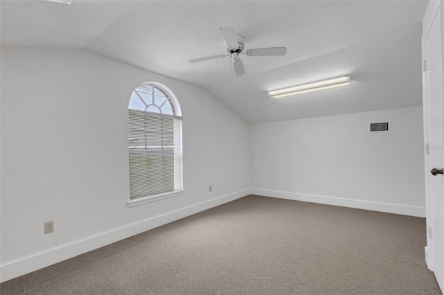 empty room with carpet flooring, ceiling fan, and lofted ceiling