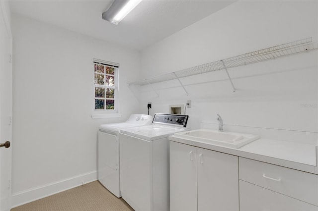 laundry area featuring cabinets, light colored carpet, washer and clothes dryer, and sink