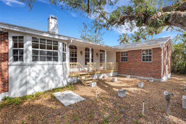 rear view of property with covered porch