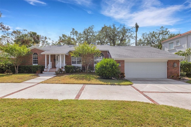 view of front of house with a garage and a front lawn