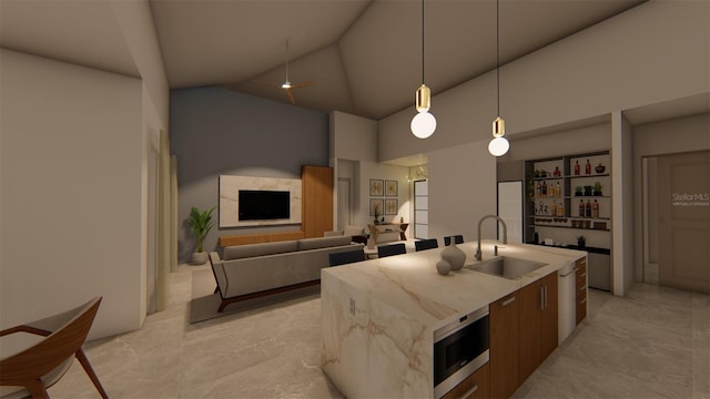 kitchen with stainless steel microwave, a kitchen island with sink, sink, high vaulted ceiling, and hanging light fixtures