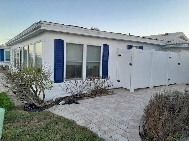 view of side of home with a patio