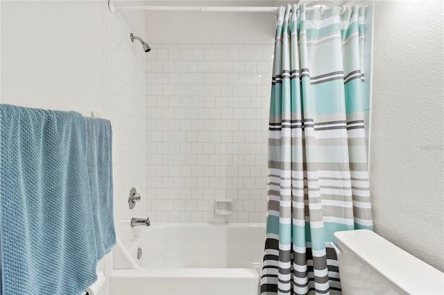 bathroom featuring shower / tub combo with curtain and toilet