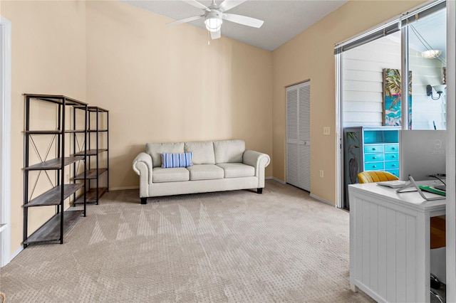 carpeted home office featuring ceiling fan and lofted ceiling