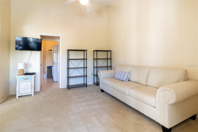 carpeted living room with ceiling fan