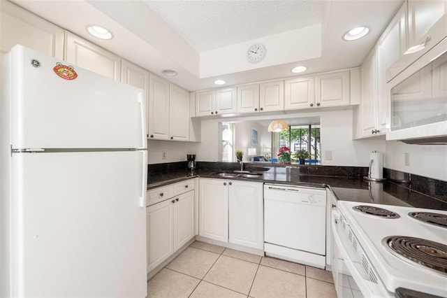 kitchen with a textured ceiling, white appliances, sink, white cabinets, and light tile patterned flooring