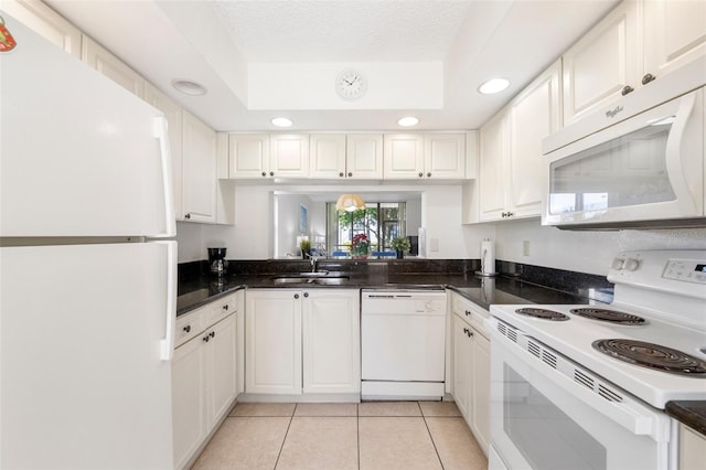 kitchen featuring white cabinetry, light tile patterned flooring, white appliances, and sink